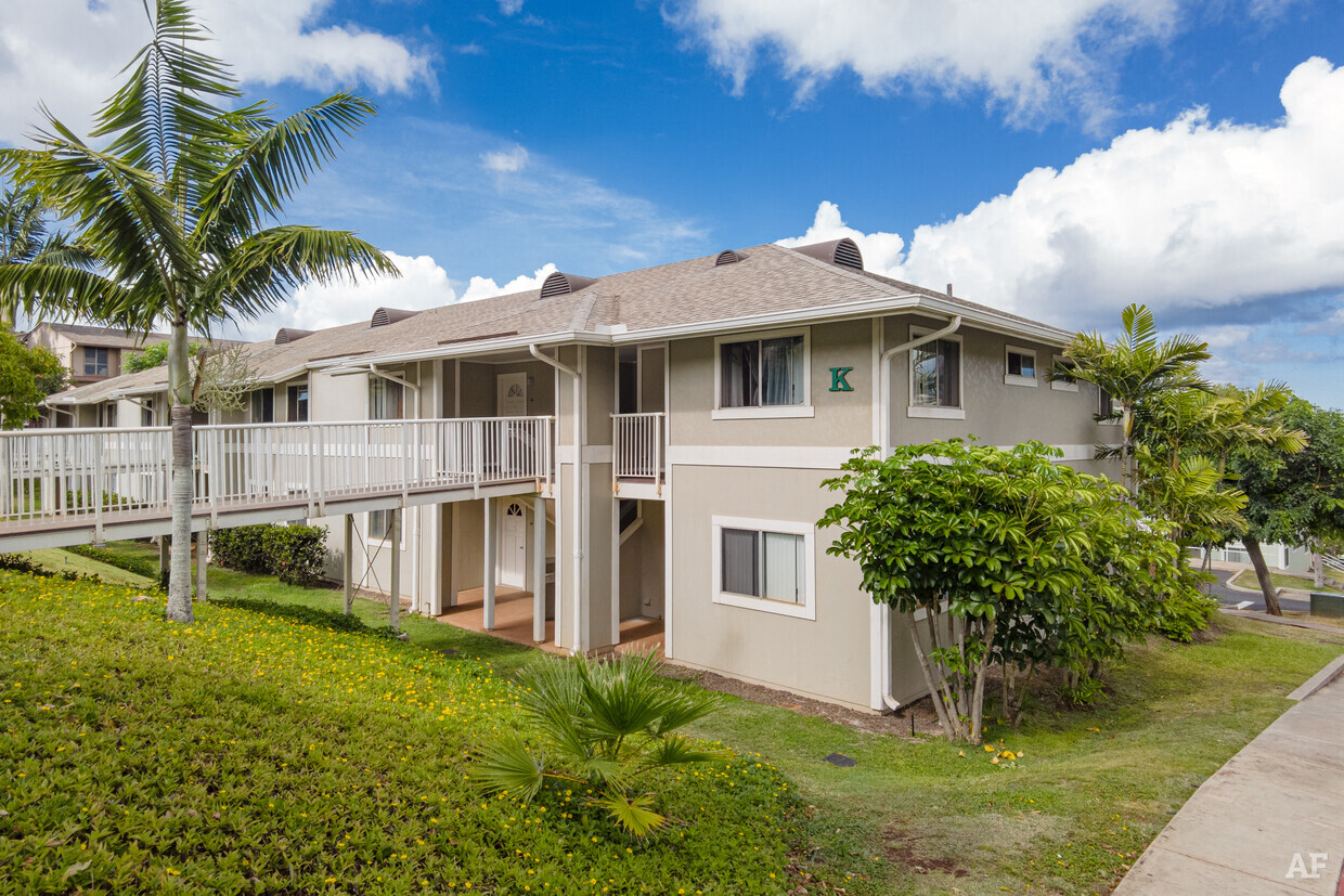 a house with a deck and a palm tree